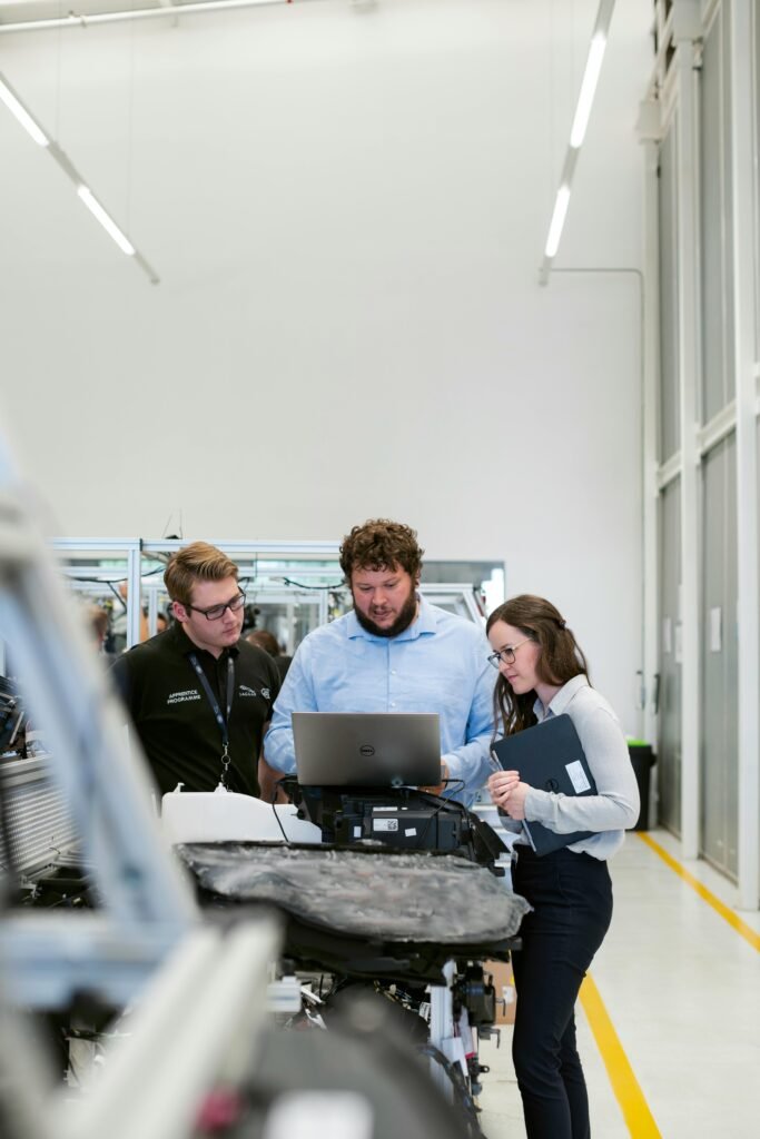 Team of engineers collaborating on a project in a modern industrial facility.